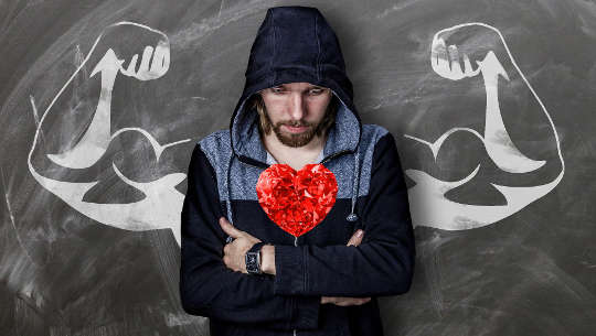 man with flexed muscles and a big heart